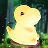 Petite lampe dinosaure à lumière chaude.