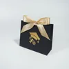 Black bag with gold ribbon