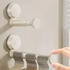 Milky white suction cup clothes hanger storage rack