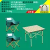 A cream-colored 52 square table with two green low moon chairs