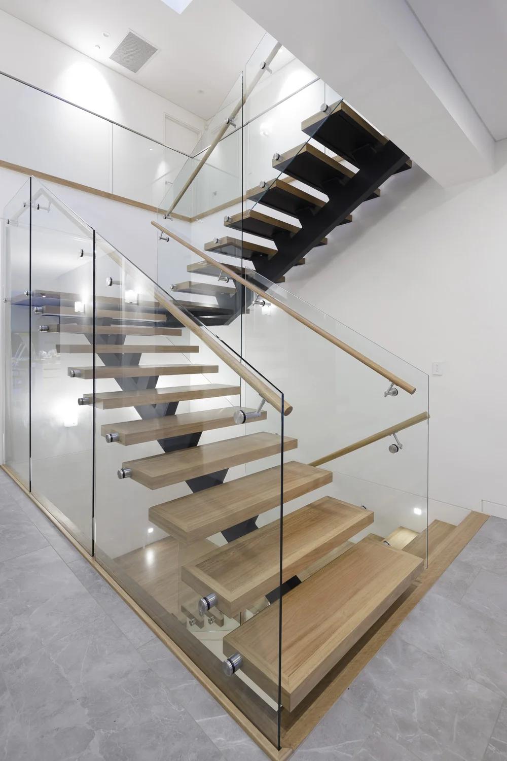 modern indoor standoff glass railing straight stairs with beech wood details