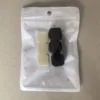 Three black items [packaged in a pearlescent film bag]