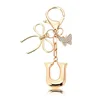Porte-clés petit papillon doré-Q