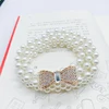 white rhinestone knot -gold
