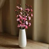 Vertical vase with 3 pink plum blossoms