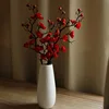 Vertical vase with 3 red plum blossoms