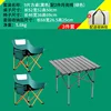 A black square table with two green low moon chairs.