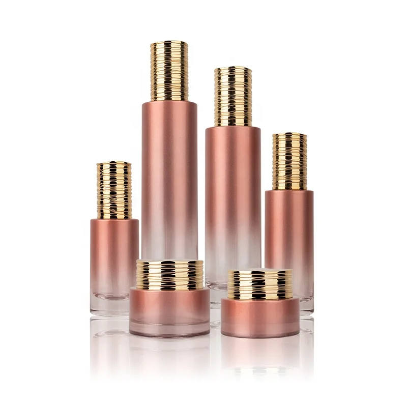 Luxury cosmetic packaging set gold cap cylinder glass bottle for cosmetics liquid packaging