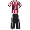 Red striped top + black overalls trousers