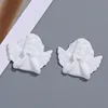 Little angel with white hands resting her cheeks