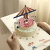 Rotating carousel style, comes with 1 envelope