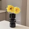 Two black vases with chrysanthemum-colored floral patterns