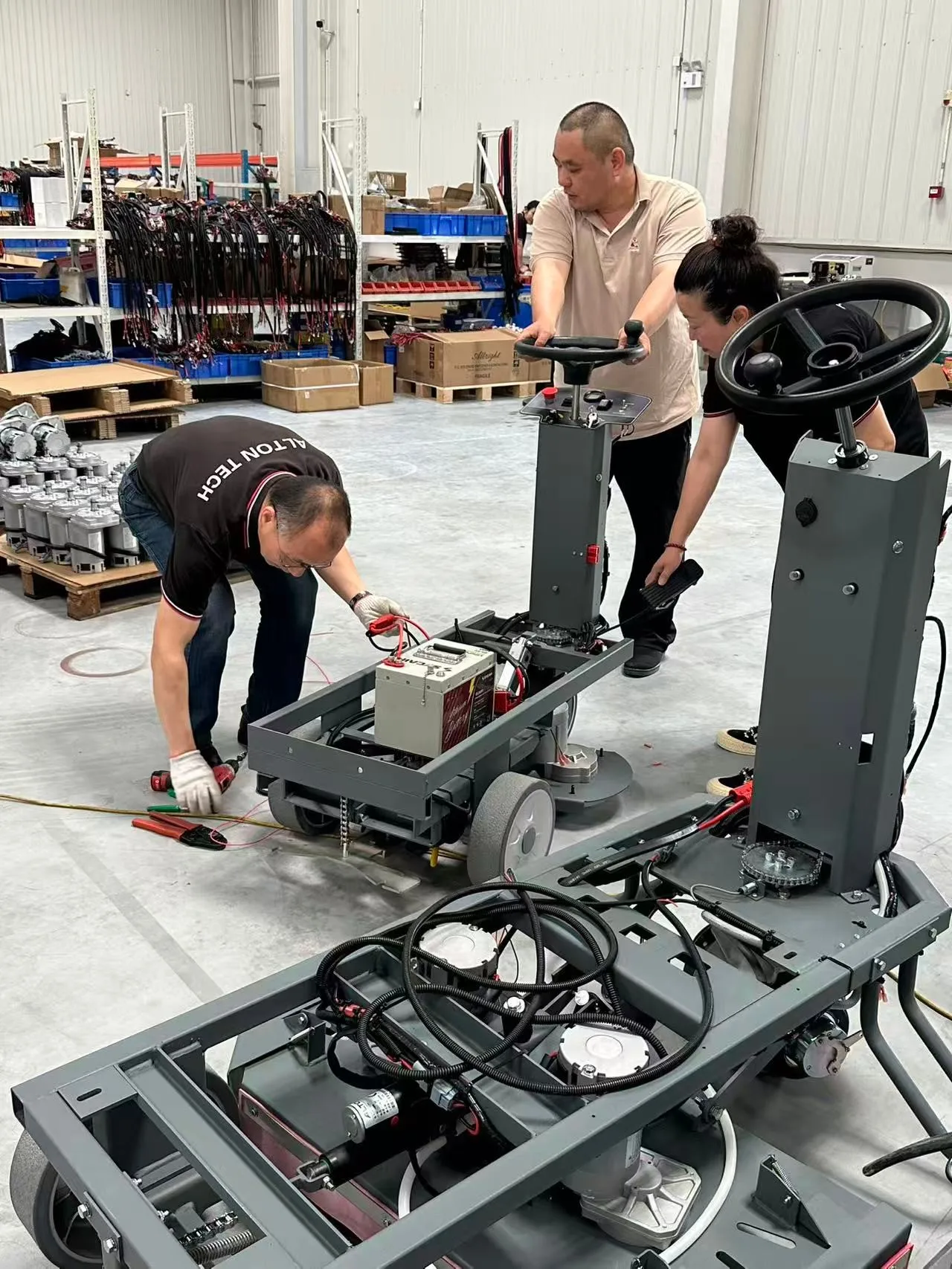 Alton Tech technical team assembling ride-on scrubbers