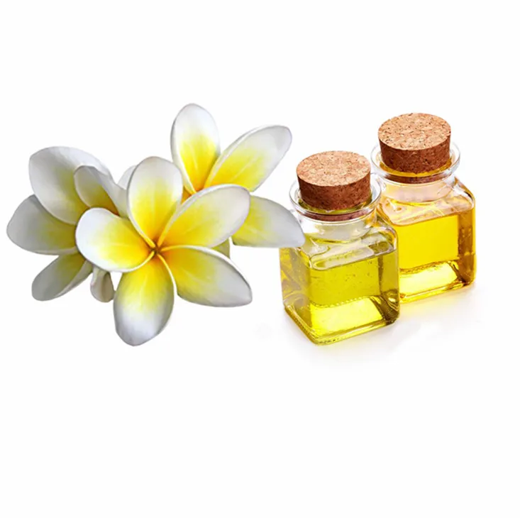 Plumeria Essential Oil Perfume and yellow plumeria flowers on the wooden  table, Stock image