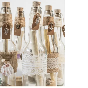 custom made wedding invitations in a glass bottle along with custom printed invitation cards